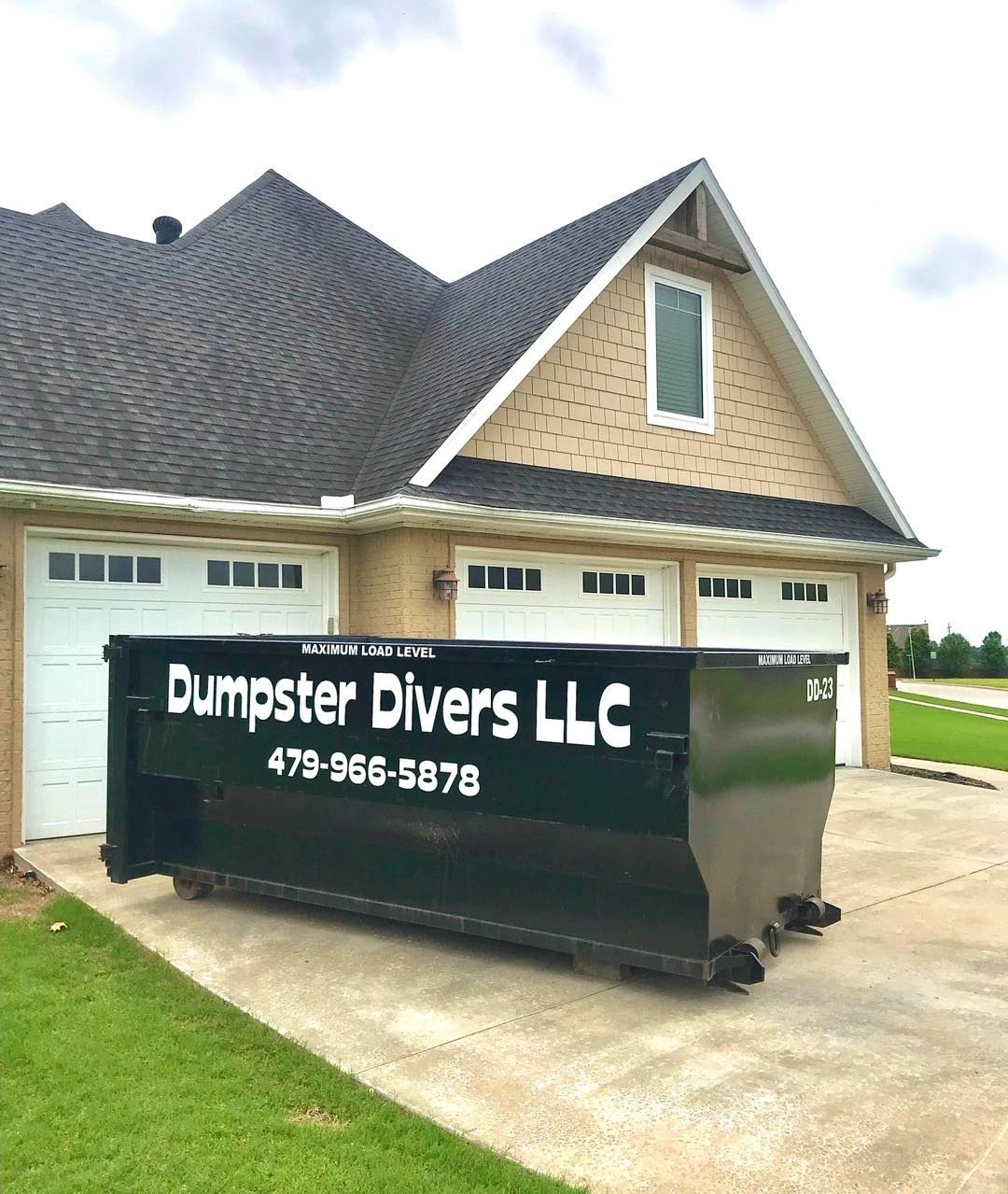 Dumpster Divers LLC dumpster in residential driveway