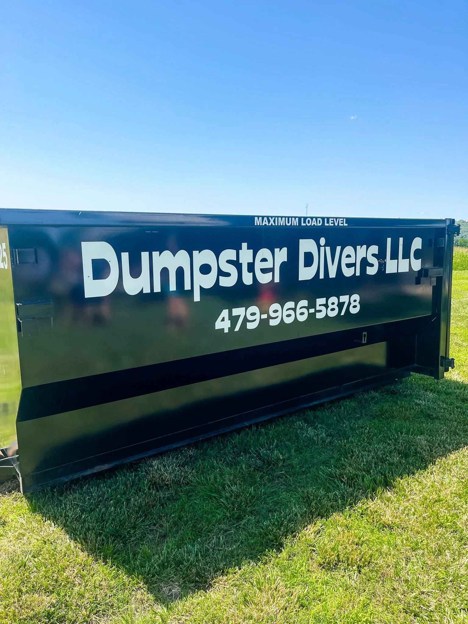Dumpster Divers LLC dumpster on grass